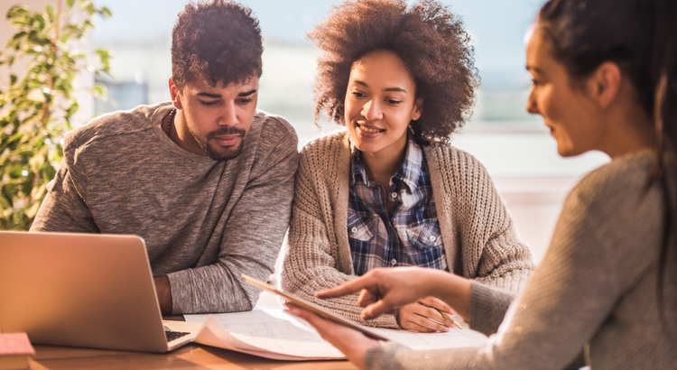 Homeowners reviewing paperwork while deciding about renting out your house